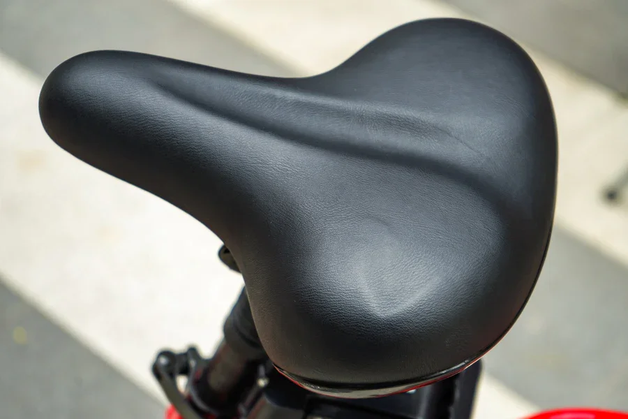 Compact Folding red fat-tire electric bike — studio side view