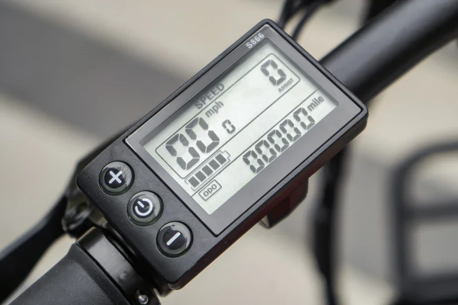 Compact Folding red fat-tire electric bike shown partially folded